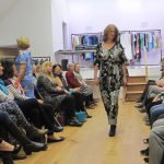 Fashion show in the village hall with female model wearing a black and white outfit