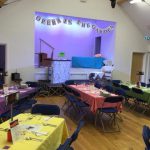 Dinner tables set in the hall for the Opera in the Garden event